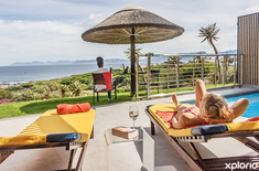 gansbaai_accommodation_crayfish_lodge_sea_and_country_guest_house_swimming_pool_area_people_in_view_copy_1759820567