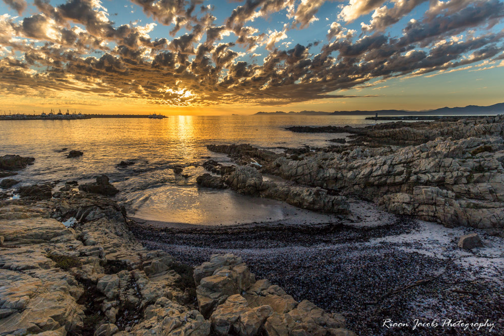 Gansbaai sunset with the old harbour to the right and the new harbour to the left.