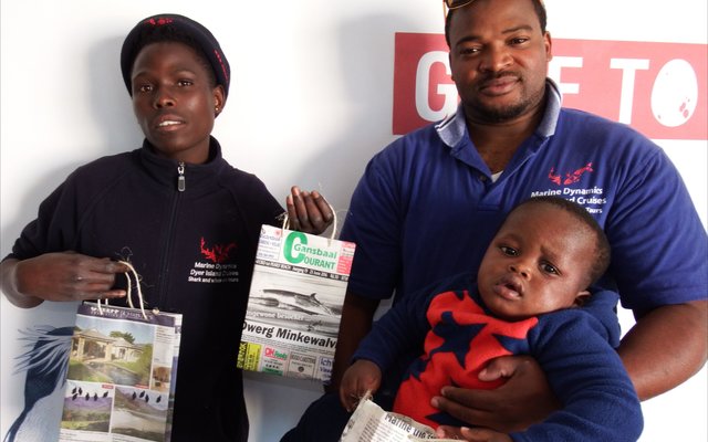 Vlnr is Njongo Mlimisi en Xolani Lawo (Bestuurder: APSS) met sy eenjarige seuntjie, Akum, wat hier spog met sy bewaringsinkopiesak.