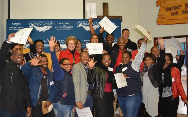 Overstrand Executive Mayor, Nicolette Botha Guthrie (pictured centre) is flanked by the group of jubilant candidates who successfully completed the Driving Licence Project, a collaboration between the Overstrand Municipality, the Department of Mineral Affairs, AFRIMAT and Overberg Driving School.