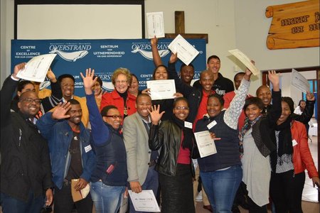 Overstrand Executive Mayor, Nicolette Botha Guthrie (pictured centre) is flanked by the group of jubilant candidates who successfully completed the Driving Licence Project, a collaboration between the Overstrand Municipality, the Department of Mineral Affairs, AFRIMAT and Overberg Driving School.
