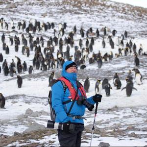 Wilfred Chivell, the “ice-man” during his and Susan Visagie’s visit to the Salisbury Plain in South Georgia, with thousands of King penguins behind him.