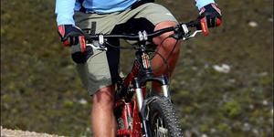 Well known dentist and enthusiastic mountain bike rider from Gansbaai, Corrie Loubser slows down at the top of the scenic Farm 215.  He was the sweeper at Saturday’s race.