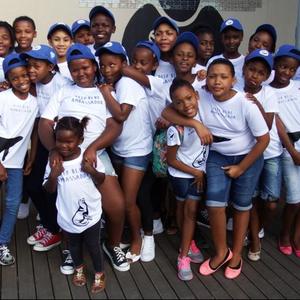 The two groups of students with Pinkey Ngewu (left), during the launch of the educational book, Deep Blue Manual, which was also written and compiled by her. The students also entertained the guests with a presentation on the Marine Big 5, by singing and sharing their knowledge.  