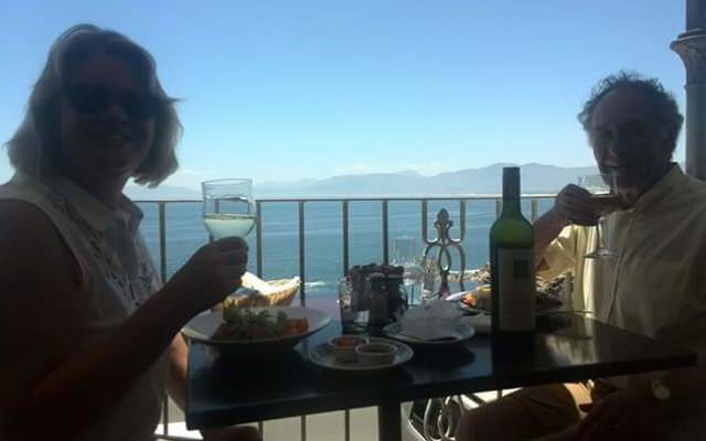 Happy guests enjoying a meal and the view.