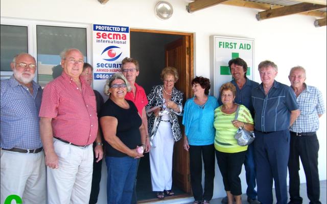 Sandra Prinsloo het ‘n aktiewe rol gespeel wat in 2013 tot die amptelike opening van die Pearly Beach Noodhulp-kamer aanleiding gegee het. Hierdie foto is destyds deur die Gansbaai Courant geneem:  voor van links is Theo Coetzer, rdl Dudley Coetzee, Ilse Keet, Suster Tertia Scholtz, Sandra Prinsloo, rdl Nicolette Botha-Guthrie (voormalige Overstrandse Uitvoerende Burgemeester), Marleen Haddon, Elize van Eeden, Hakkie Hückstedt, rdl Pieter Scholtz en Daan Fouchè.