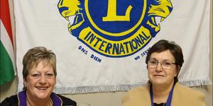 A  newly  painted  flag  for  a new season at the Gansbaai Lions  Club.   Past  District Governor, Paula Lang  and  Marietta  Hatting  toast on  the  success of  the  2017/18 season.