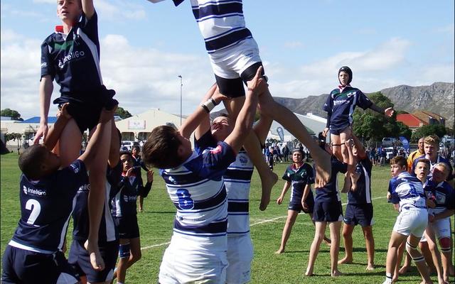 Nieldrè Groenewald spring hoog vir die bal in die lynstaan, met Charl Eksteen (voor) en Billy Brown (direk agter hom) wat hom ondersteun. 