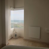 The master suite offers space and sea views from the comfort of the bed