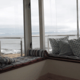 Contemplate with a view -- this corner window seat accommodates a number of people, or just two adults if each of you enjoy stretching out completely