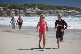 Family and kinds running on the beach