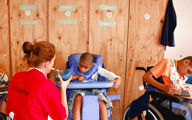 Elim_home_volunteer_feeding_child_1518417993_1573474963