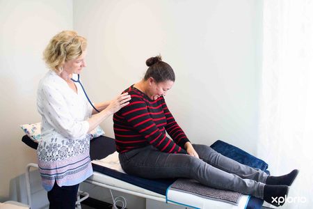 hermanus_businesses_gp_care_hermanus_doctor_checking_patient_sitting_1574336985