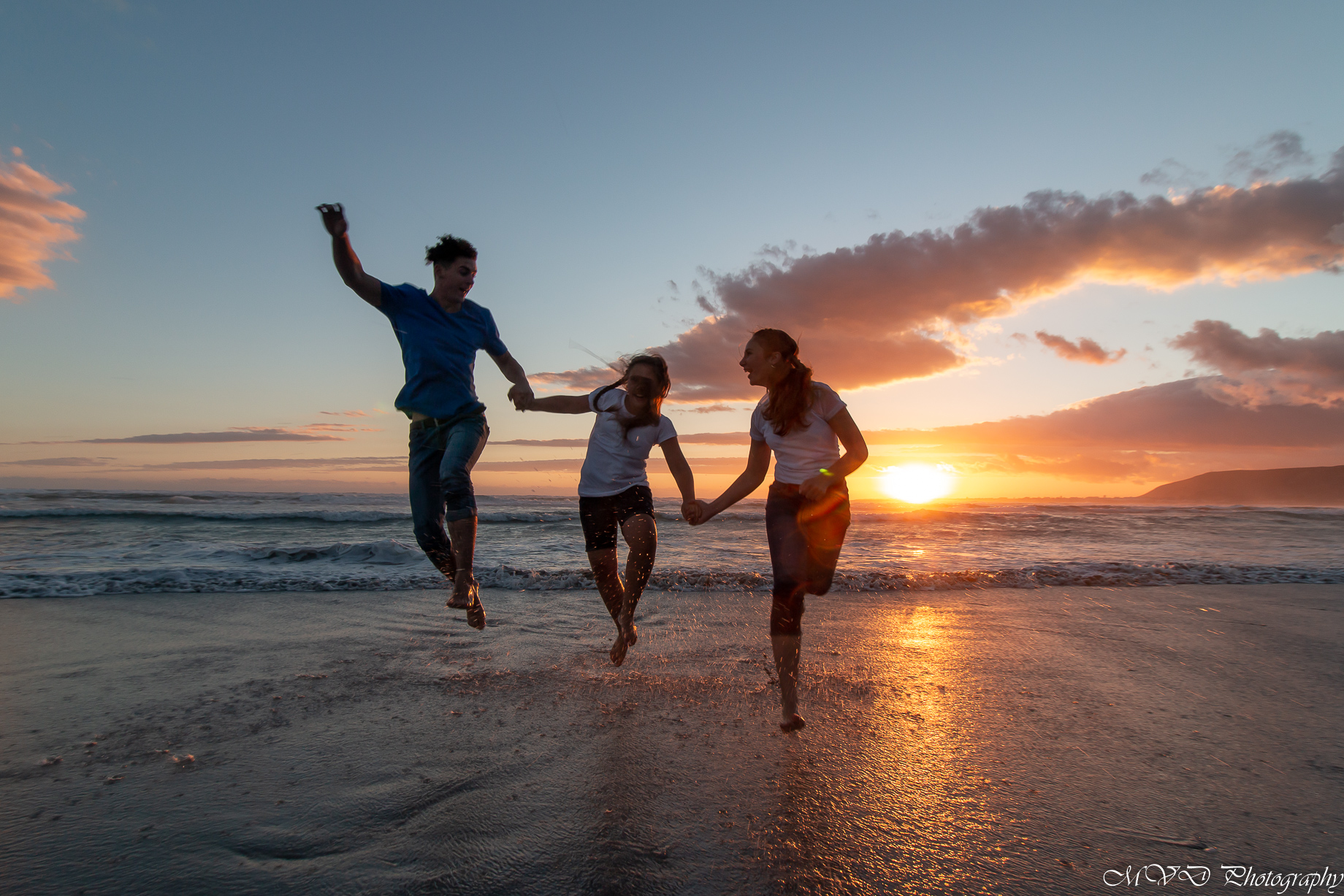 People having fun in the beaches of Hermanus at sunset 